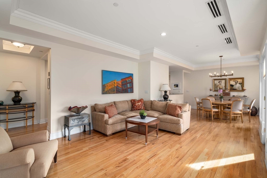 630 Hammond Street, Unit 102 Brookline, MA 02467 - Photo 6 of 19 a living room with furniture and a wooden floor