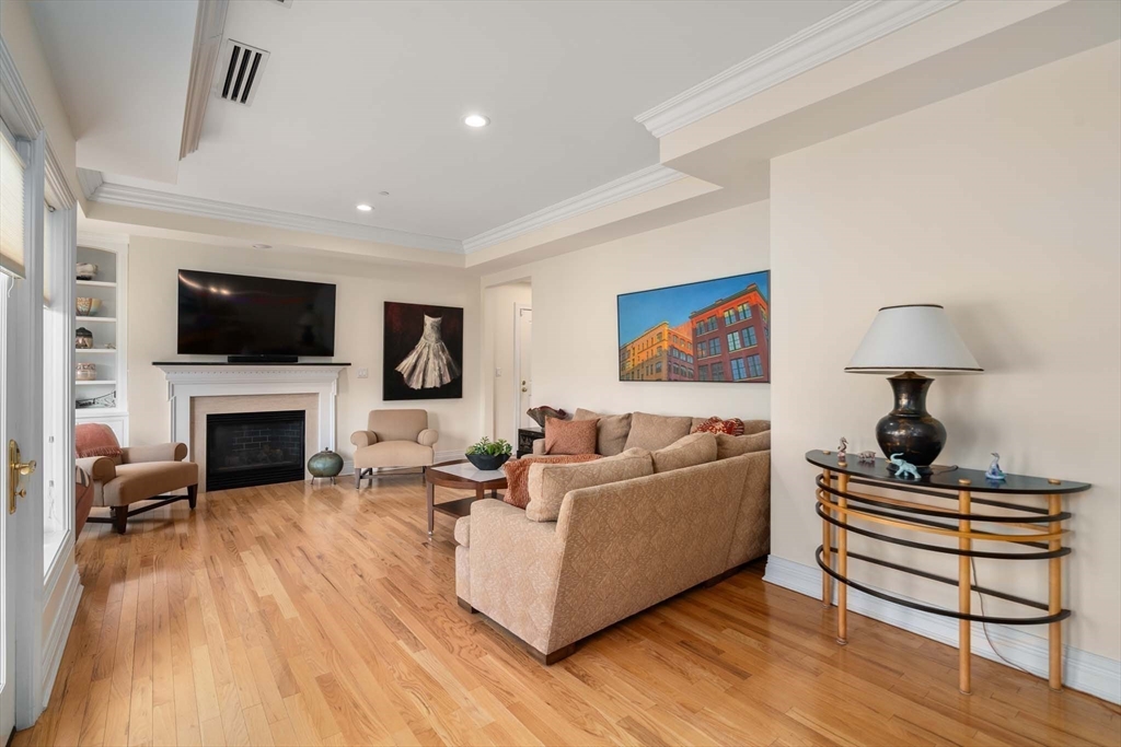 630 Hammond Street, Unit 102 Brookline, MA 02467 - Photo 7 of 19 a living room with furniture and a fireplace