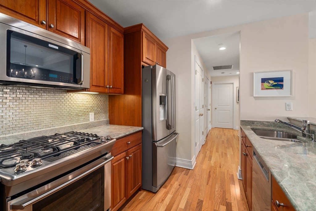 630 Hammond Street, Unit 102 Brookline, MA 02467 - Photo 10 of 19 a kitchen with a stove and a microwave