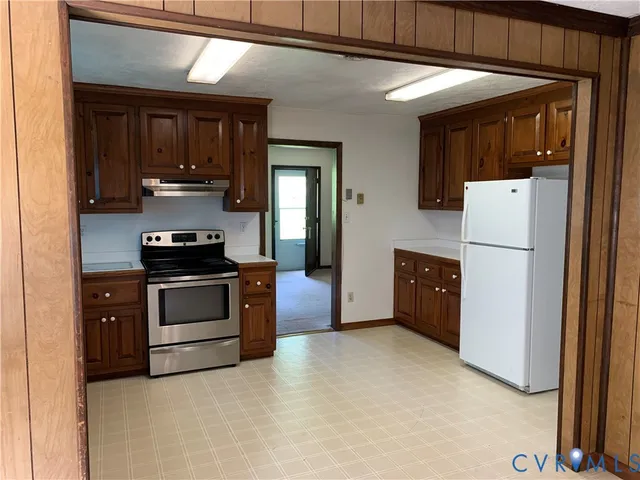 a kitchen with a refrigerator and a stove
