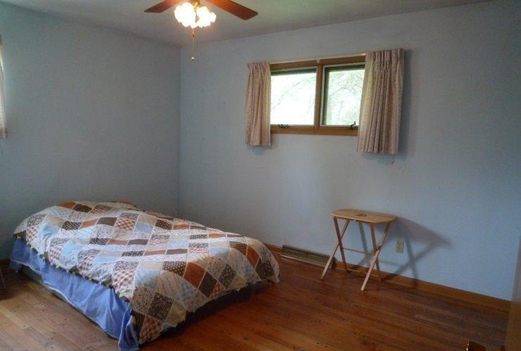9309 Kleinman Road Highland, IN 46322 - Photo 7 of 10 a bedroom with a bed and a chandelier