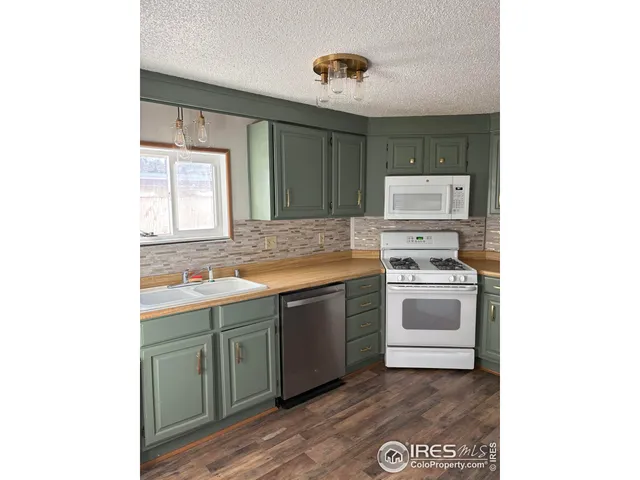 a kitchen with a stove cabinets and a sink