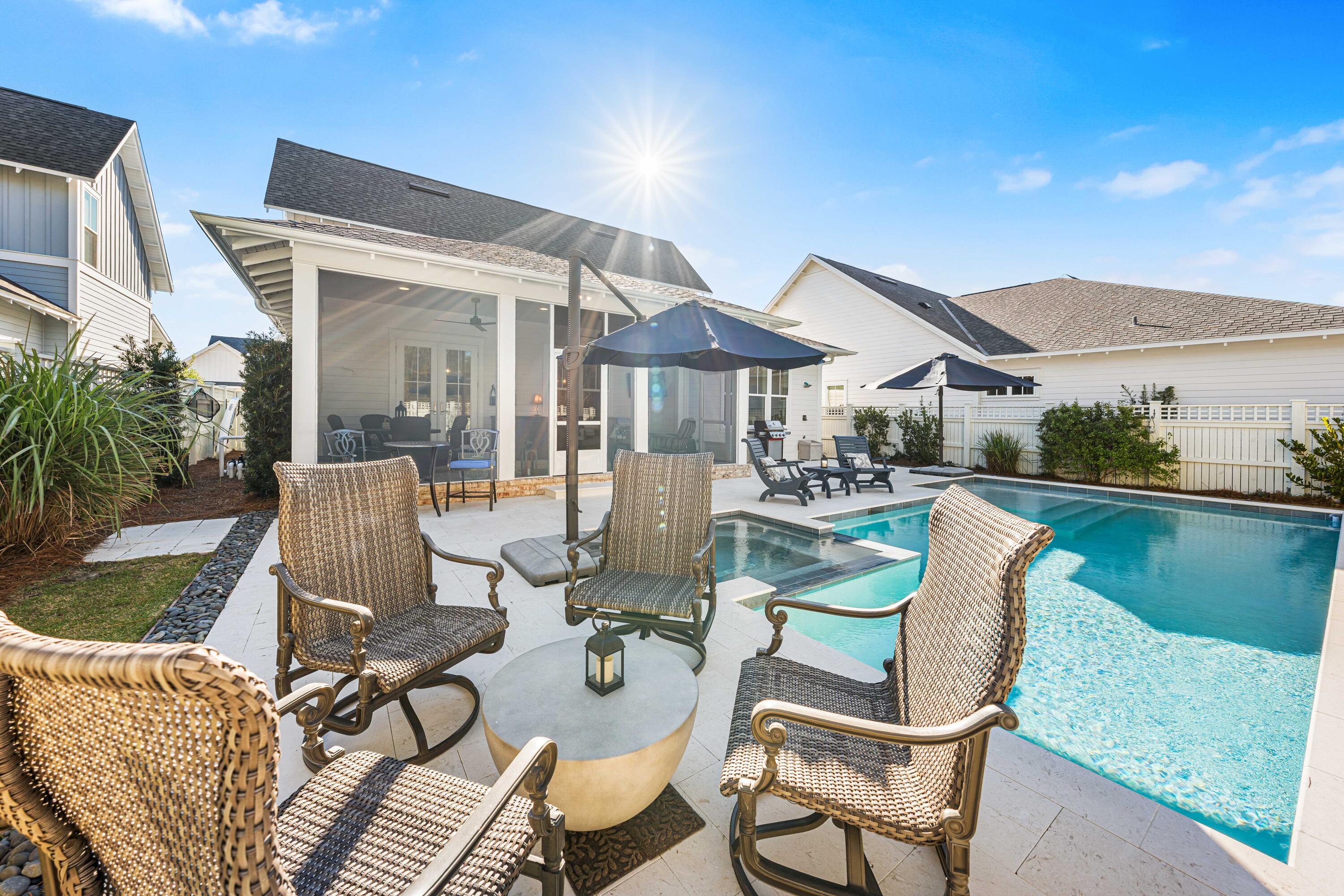 41 East Firethorn Cir Inlet Beach Inlet Beach, FL 32461 - Photo 11 of 66 a view of a patio with table and chairs potted plants with wooden floor and fence