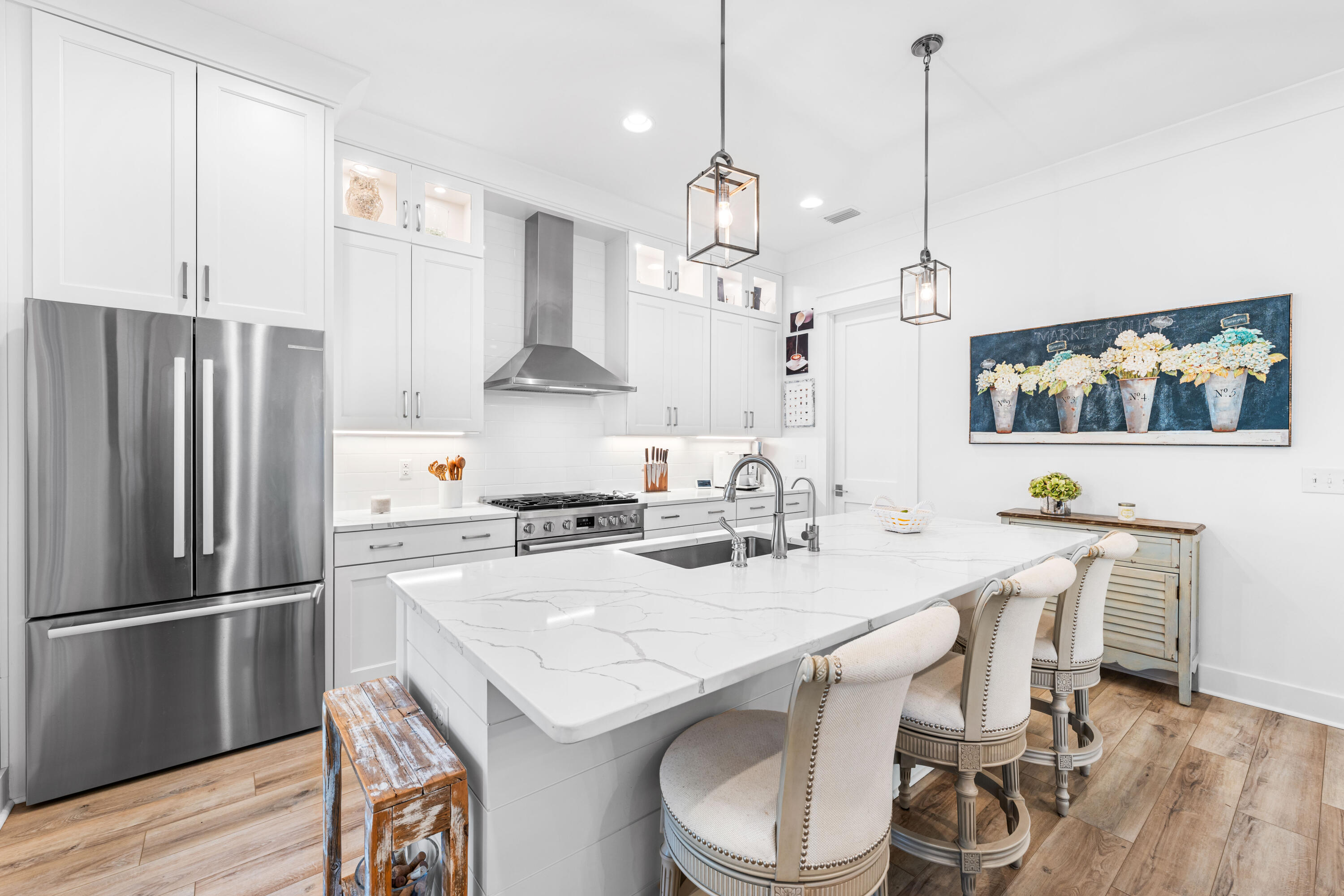 41 East Firethorn Cir Inlet Beach Inlet Beach, FL 32461 - Photo 40 of 66 a kitchen with stainless steel appliances a dining table chairs refrigerator and sink