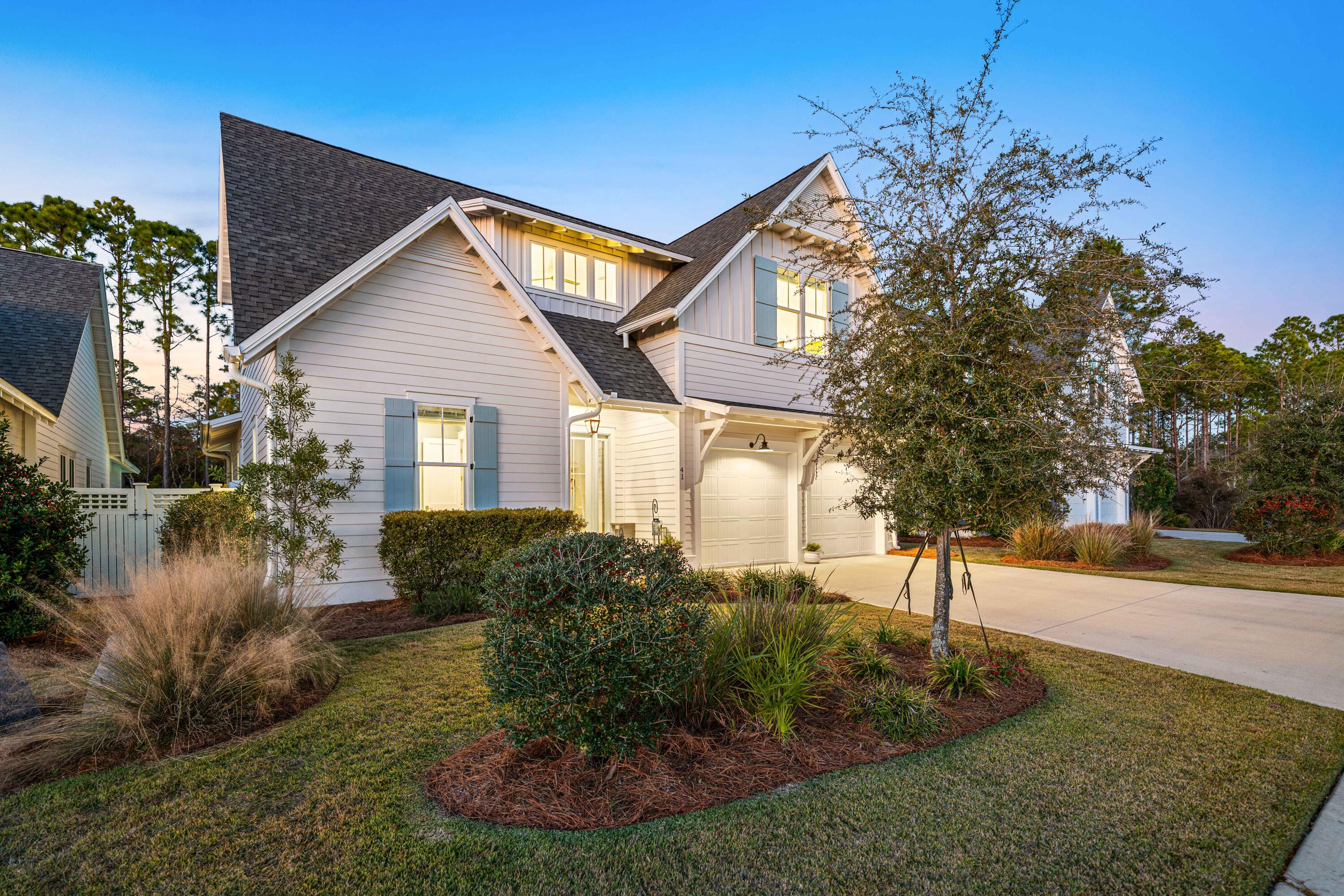 41 East Firethorn Cir Inlet Beach Inlet Beach, FL 32461 - Photo 4 of 66 a front view of a house with garden