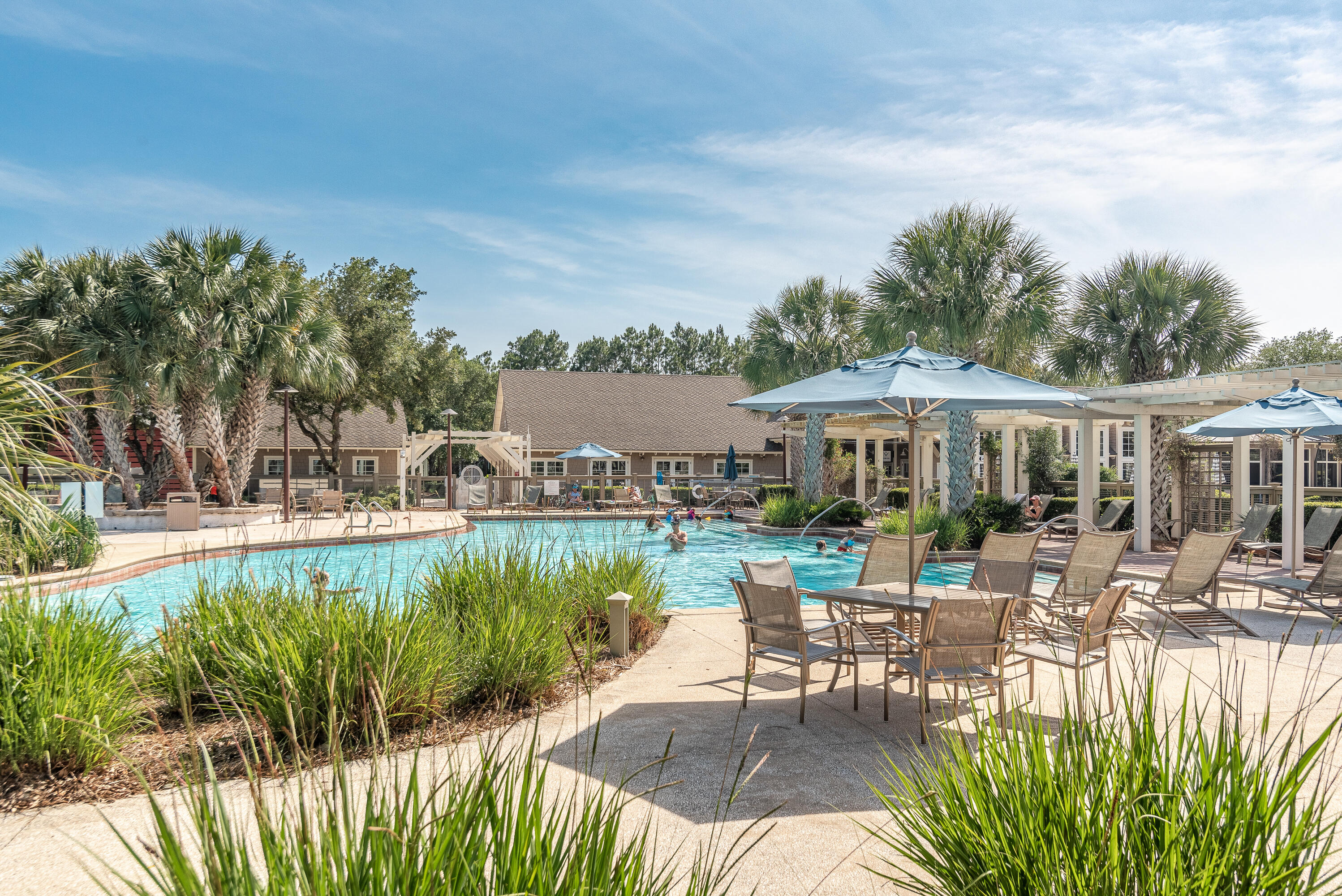 41 East Firethorn Cir Inlet Beach Inlet Beach, FL 32461 - Photo 62 of 66 a view of a patio with table and chairs potted plants and palm trees