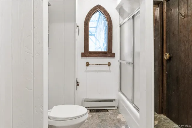 a bathroom with a toilet a sink and a window