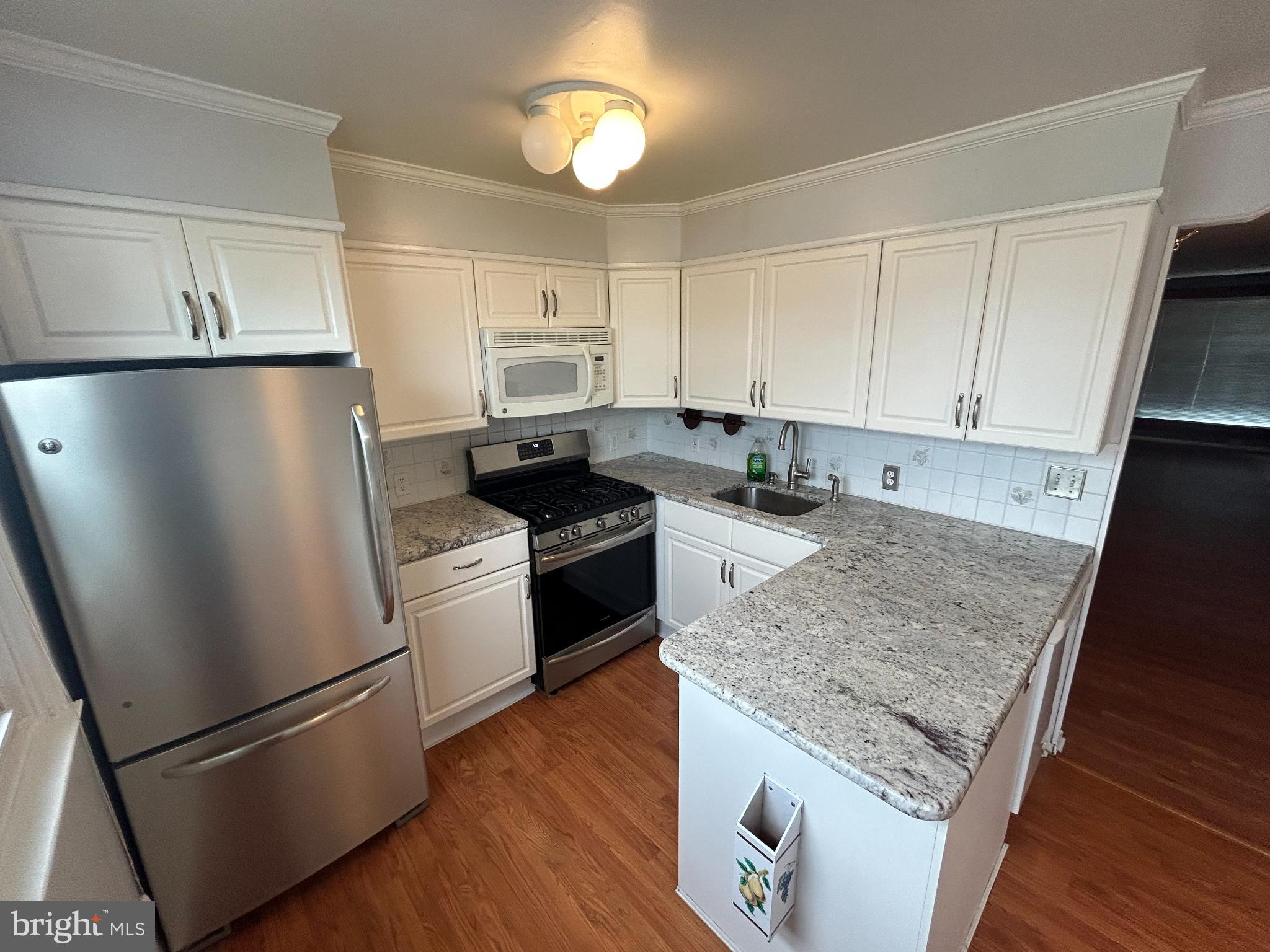 10830 Perrin Road Philadelphia, PA 19154 - Photo 2 of 25 a kitchen with granite countertop stainless steel appliances a refrigerator a stove a sink and cabinets