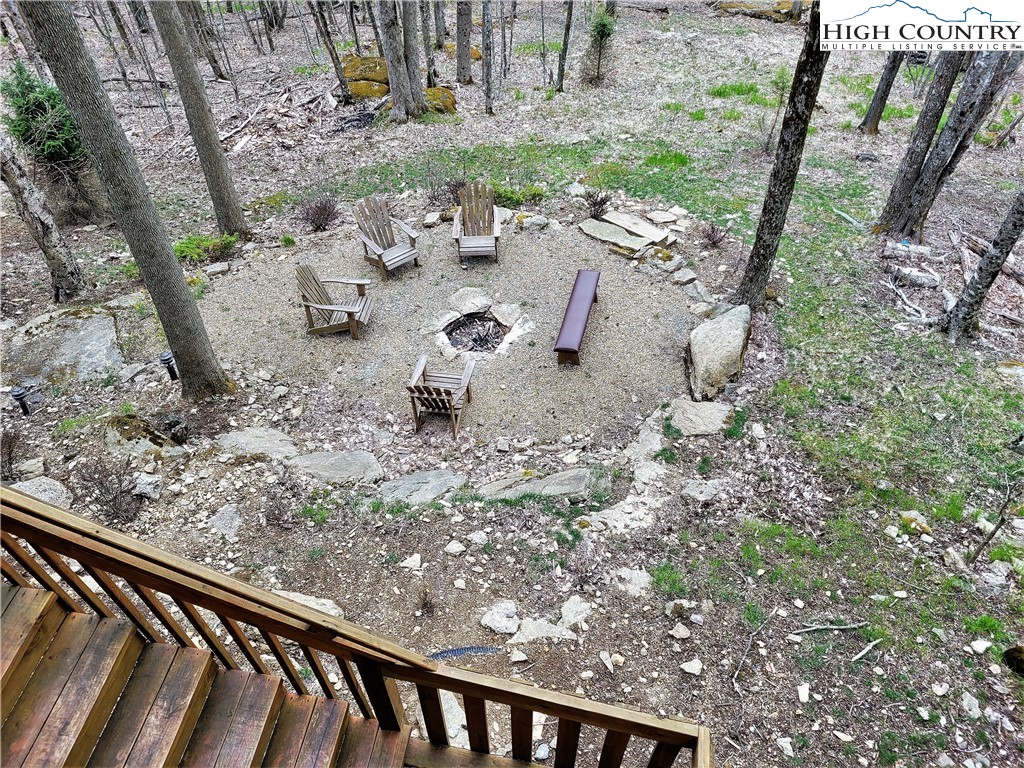 143 Tamarack Road Beech Mountain, NC 28604 - Photo 16 of 47 a view of a backyard with chair and wooden fence