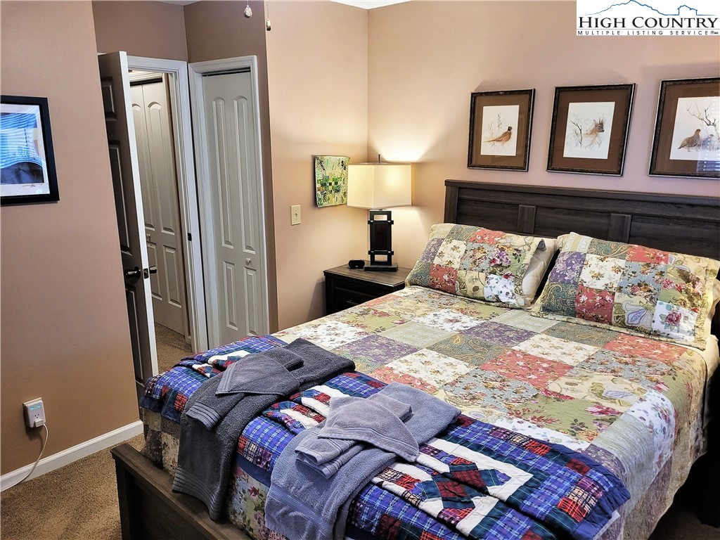 143 Tamarack Road Beech Mountain, NC 28604 - Photo 19 of 47 a bedroom with a bed and painting on the wall