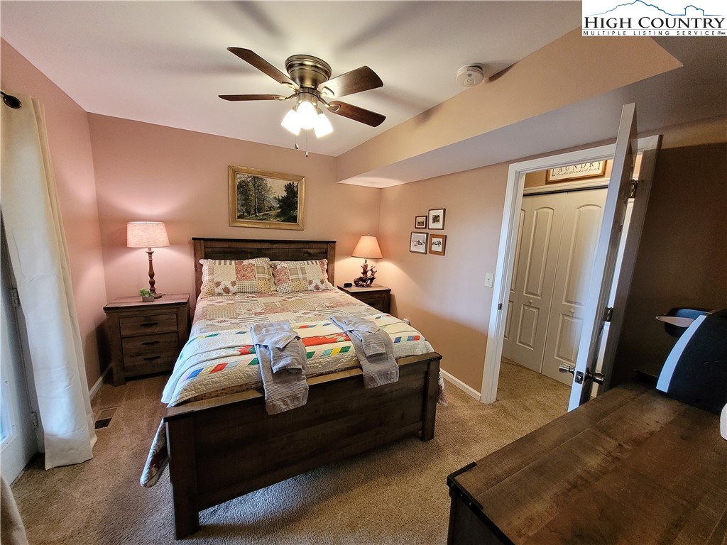 143 Tamarack Road Beech Mountain, NC 28604 - Photo 22 of 47 a bedroom with a bed and a chandelier