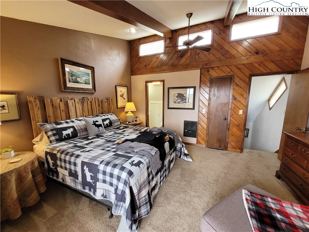 143 Tamarack Road Beech Mountain, NC 28604 - Photo 29 of 47 a bed room with a bed and a couch