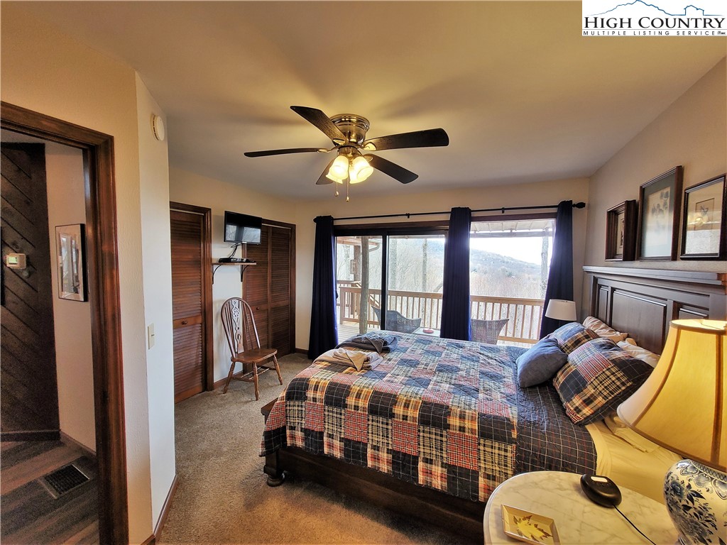 143 Tamarack Road Beech Mountain, NC 28604 - Photo 9 of 47 a bedroom with bed and windows