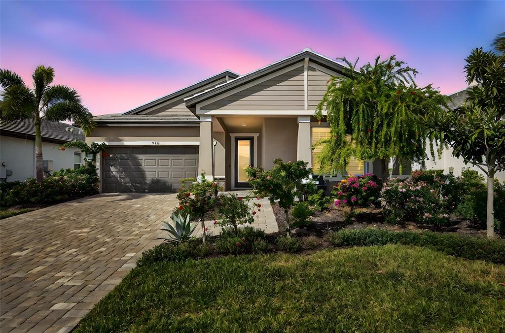 17744 Savory Mist Circle Lakewood Ranch, FL 34211 - Photo 1 of 55 a front view of a house with a garden
