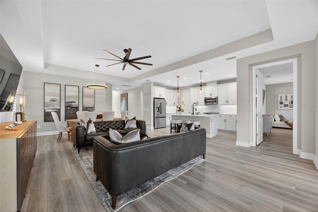 17744 Savory Mist Circle Lakewood Ranch, FL 34211 - Photo 11 of 55 a living room with furniture kitchen and a wooden floor