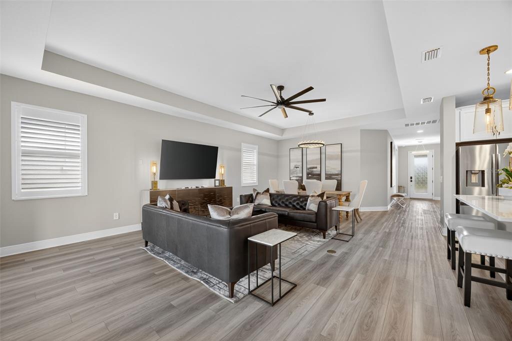 17744 Savory Mist Circle Lakewood Ranch, FL 34211 - Photo 13 of 55 a living room with furniture and a flat screen tv