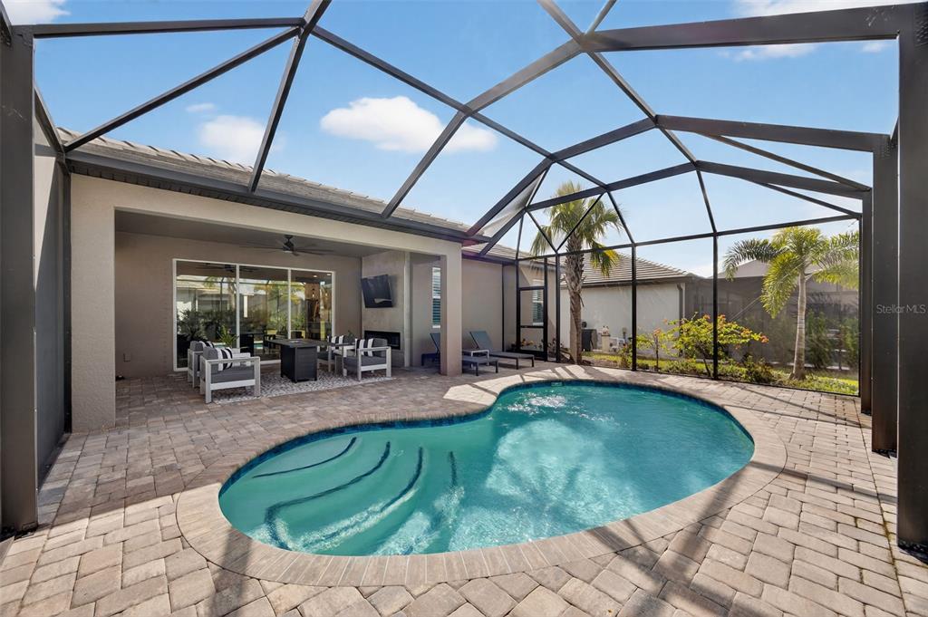 17744 Savory Mist Circle Lakewood Ranch, FL 34211 - Photo 15 of 55 a view of a swimming pool with a lounge chairs