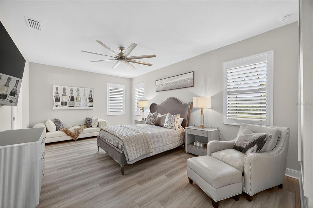 17744 Savory Mist Circle Lakewood Ranch, FL 34211 - Photo 18 of 55 a bedroom with two beds and a chandelier