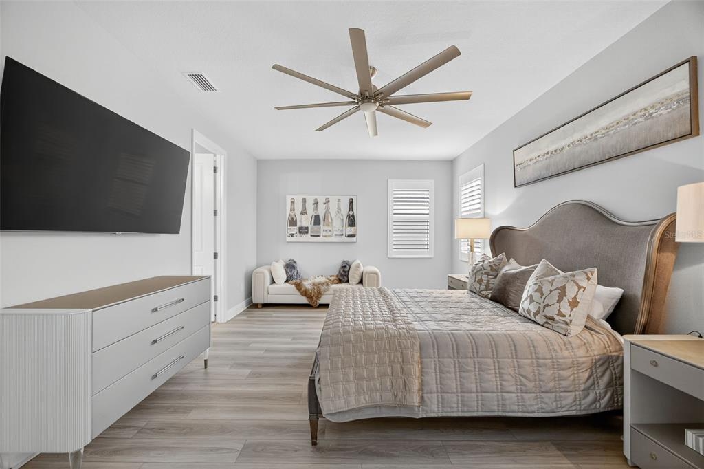 17744 Savory Mist Circle Lakewood Ranch, FL 34211 - Photo 19 of 55 a bedroom with a bed and a flat screen tv