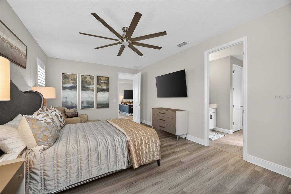17744 Savory Mist Circle Lakewood Ranch, FL 34211 - Photo 20 of 55 a bedroom with a bed and a flat screen tv