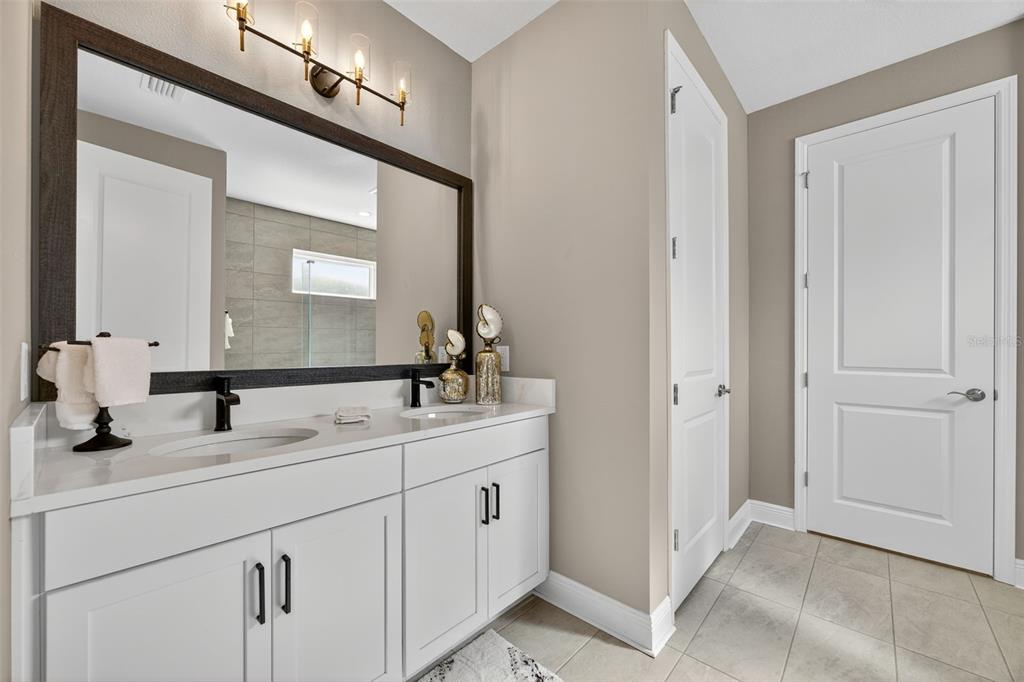 17744 Savory Mist Circle Lakewood Ranch, FL 34211 - Photo 21 of 55 a bathroom with a double vanity sink and mirror