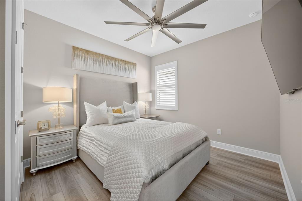 17744 Savory Mist Circle Lakewood Ranch, FL 34211 - Photo 24 of 55 a bedroom with a large bed chandelier and a window