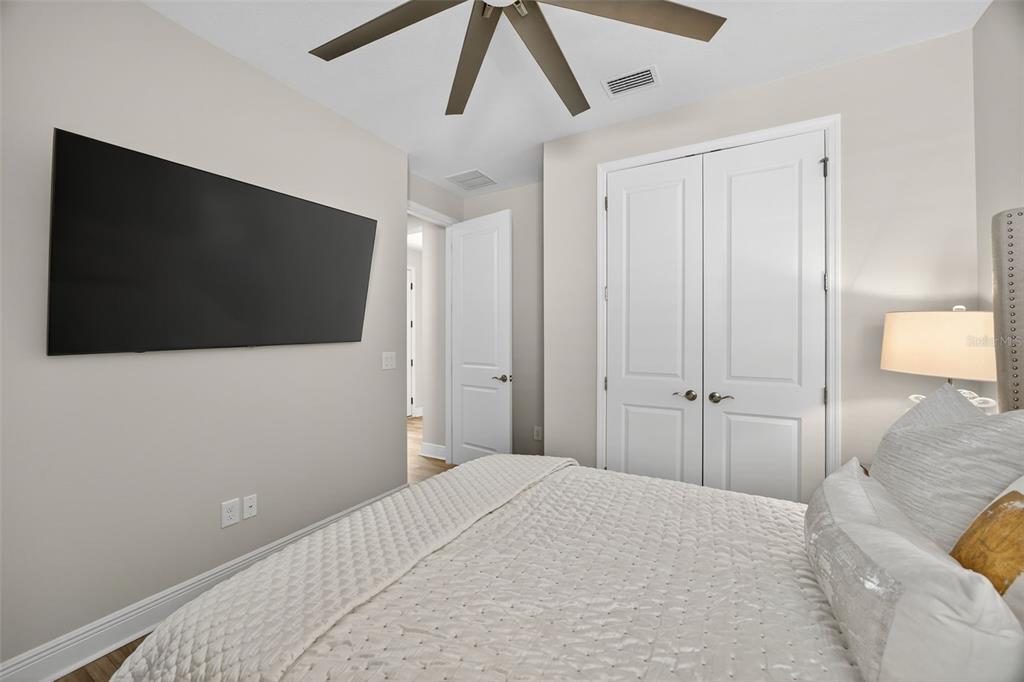 17744 Savory Mist Circle Lakewood Ranch, FL 34211 - Photo 25 of 55 a bedroom with a bed and a flat screen tv