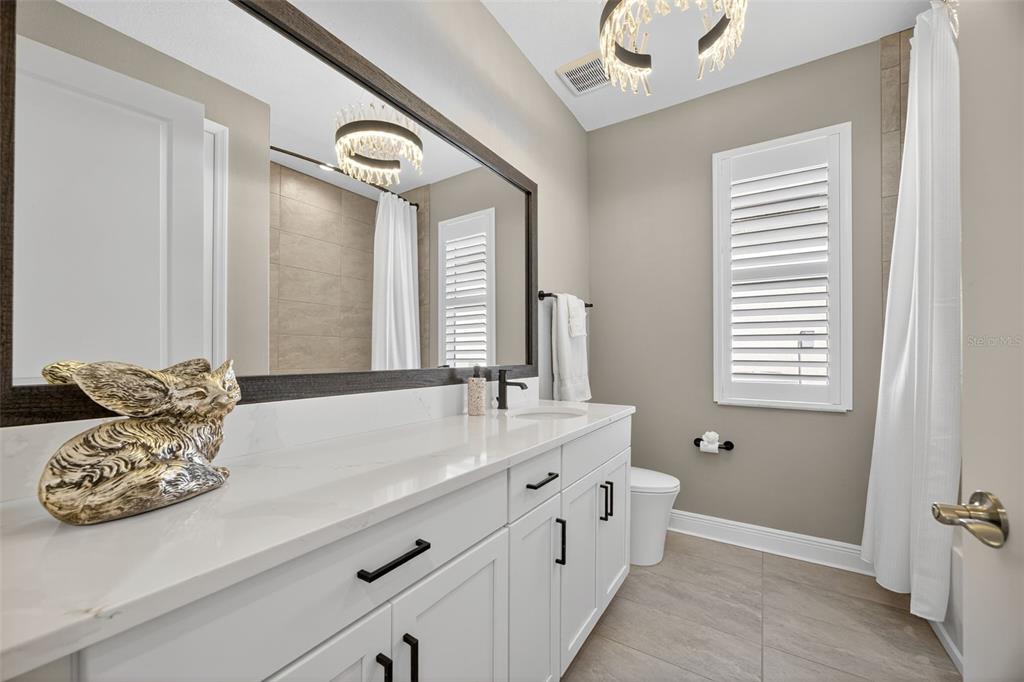 17744 Savory Mist Circle Lakewood Ranch, FL 34211 - Photo 26 of 55 a bathroom with a bathtub and a sink