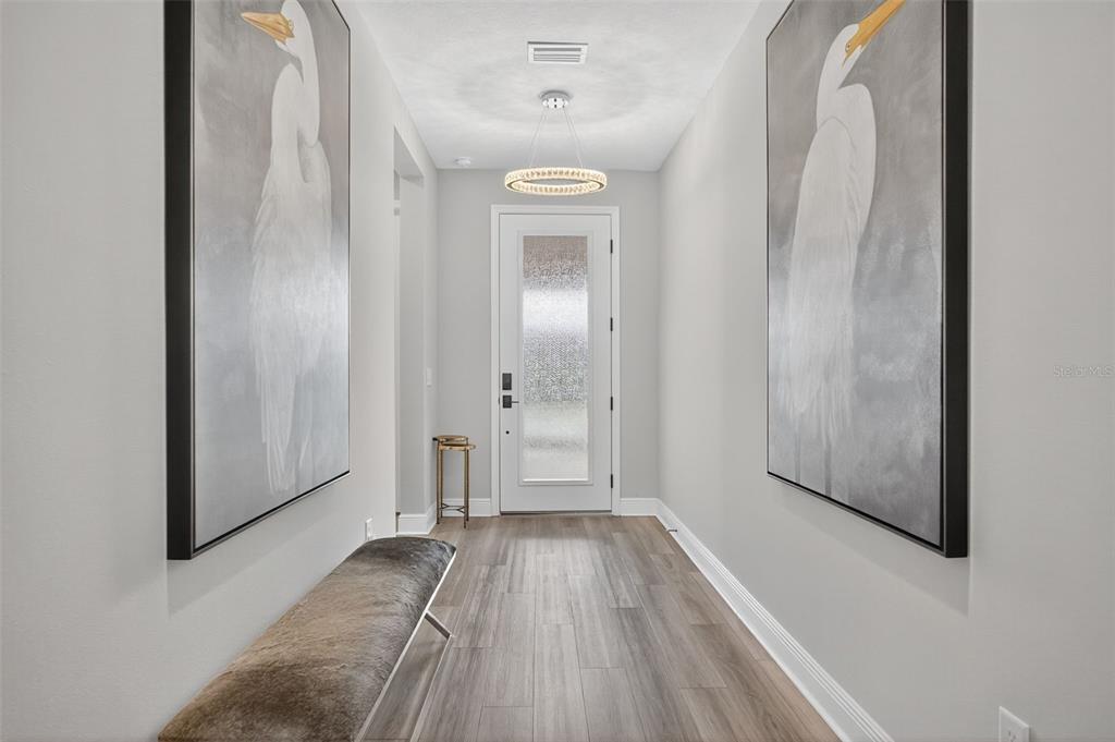 17744 Savory Mist Circle Lakewood Ranch, FL 34211 - Photo 32 of 55 a view of a room with wooden floor and a hallway