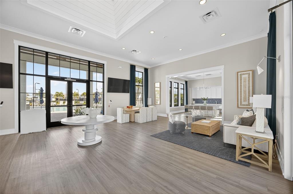 17744 Savory Mist Circle Lakewood Ranch, FL 34211 - Photo 34 of 55 a living room with couches and a dining table with wooden floor
