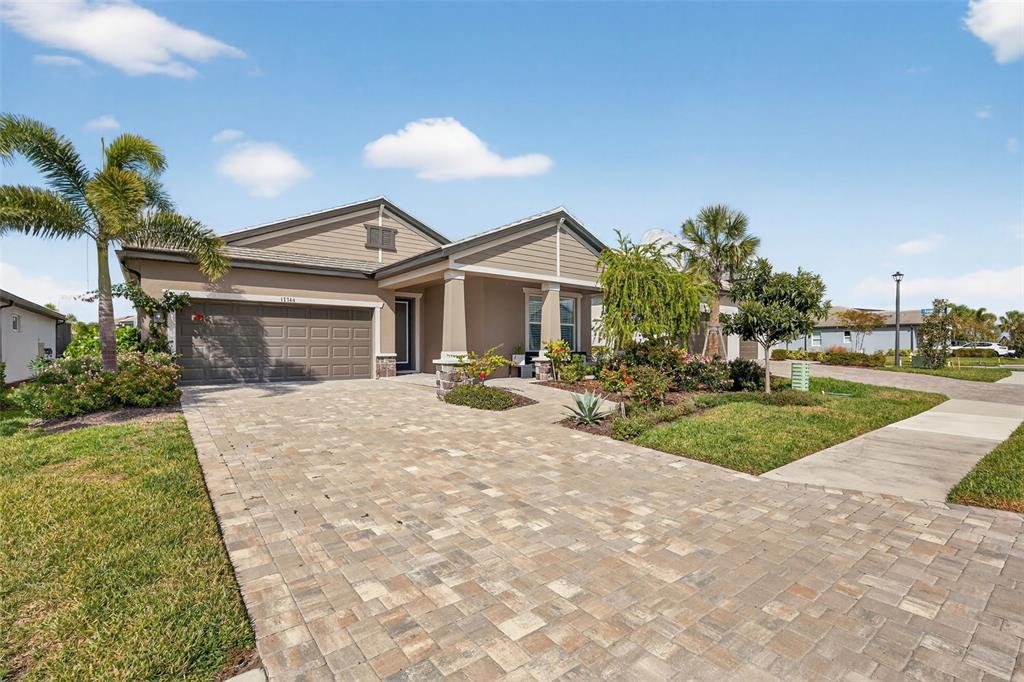 17744 Savory Mist Circle Lakewood Ranch, FL 34211 - Photo 43 of 55 a front view of a house with a yard and garage