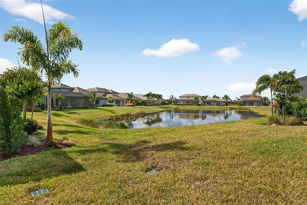 17744 Savory Mist Circle Lakewood Ranch, FL 34211 - Photo 47 of 55 a view of a lake with a big yard