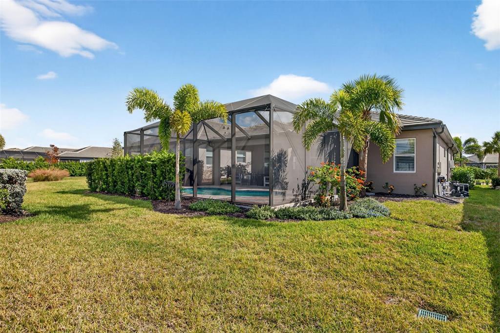 17744 Savory Mist Circle Lakewood Ranch, FL 34211 - Photo 48 of 55 a view of a house with a yard and a garden