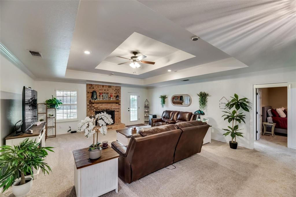 579 South Hitt Street Boyd, TX 76023 - Photo 12 of 34 Large Living Room with Tray Ceiling and Woof Burning Fire Place