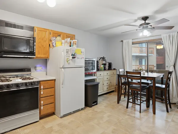 a kitchen with cabinets and stainless steel appliances