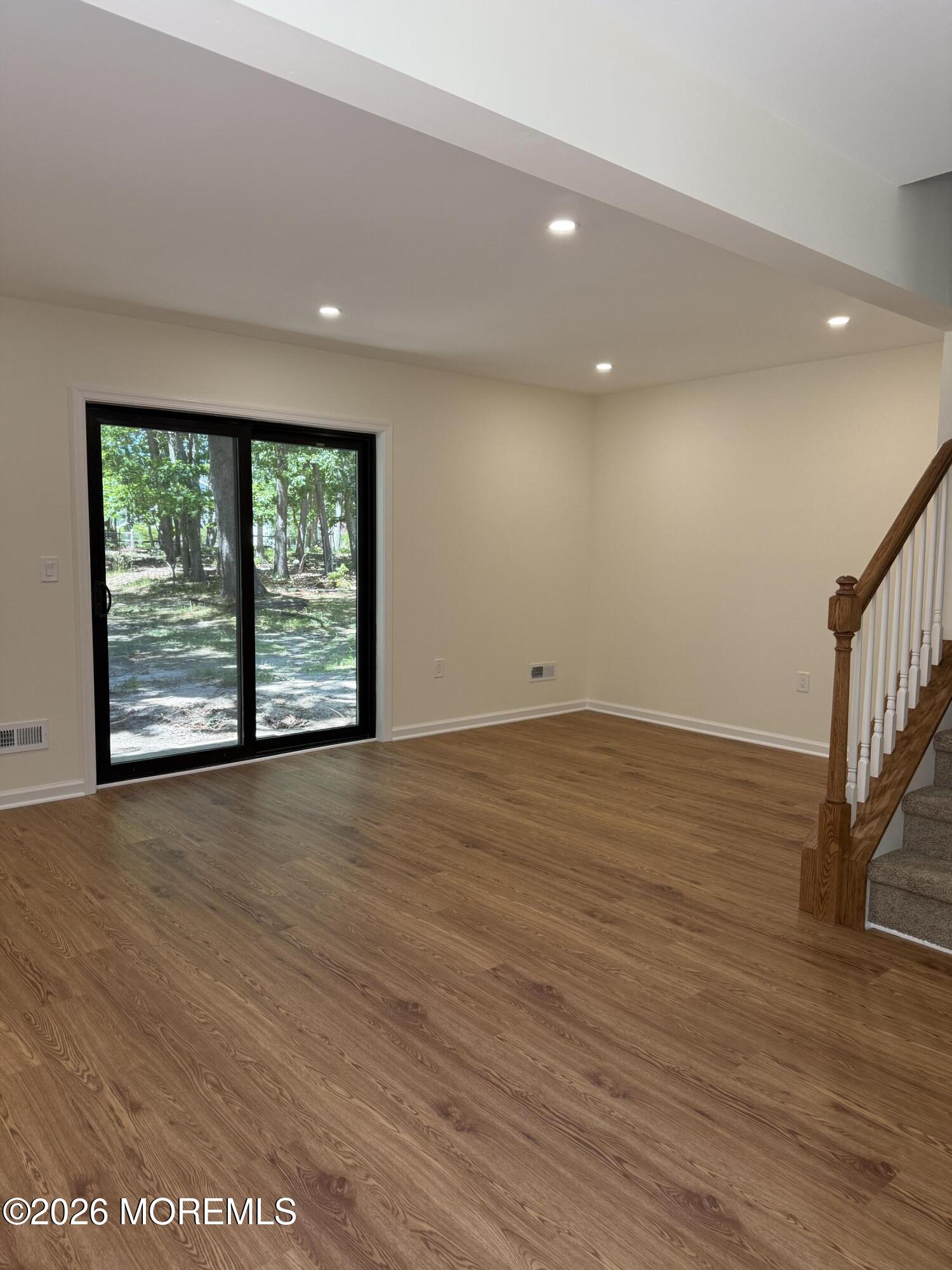 5 Canary Circle Howell, NJ 07731 - Photo 7 of 32 an empty room with wooden floor and windows