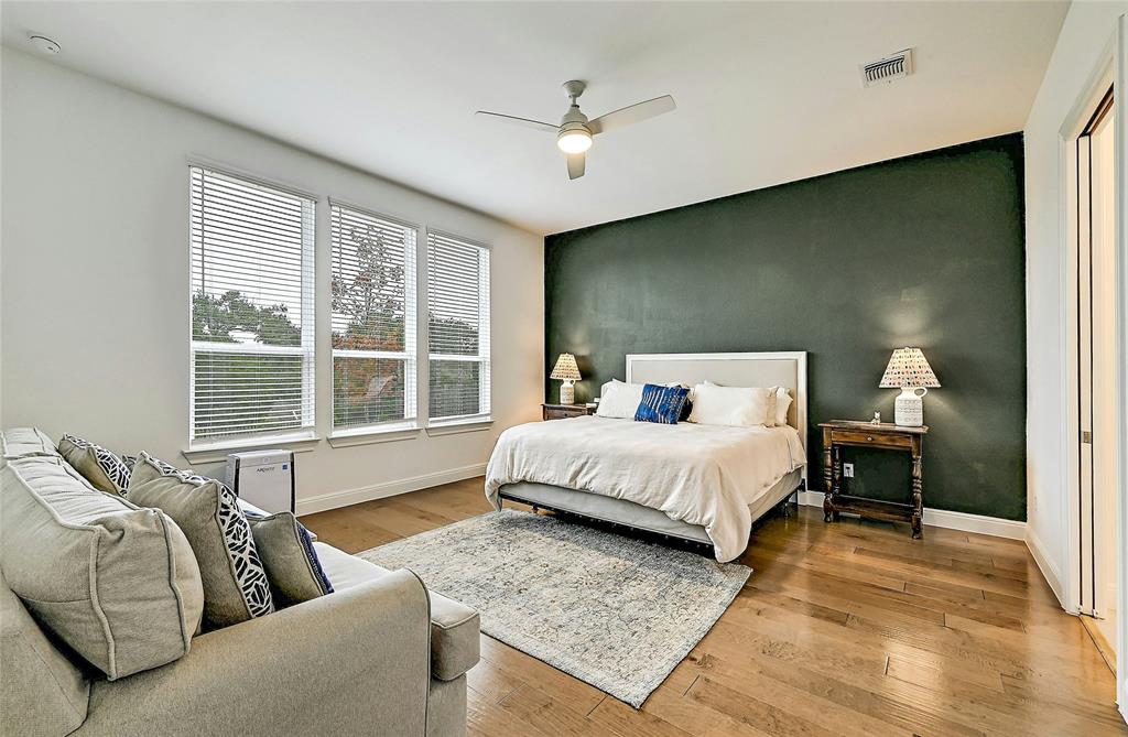 170 Climbing Rock Loop Dripping Springs, TX 78620 - Photo 10 of 30 Hardwood floors and a soothing color palette create a restful retreat in this primary bedroom.