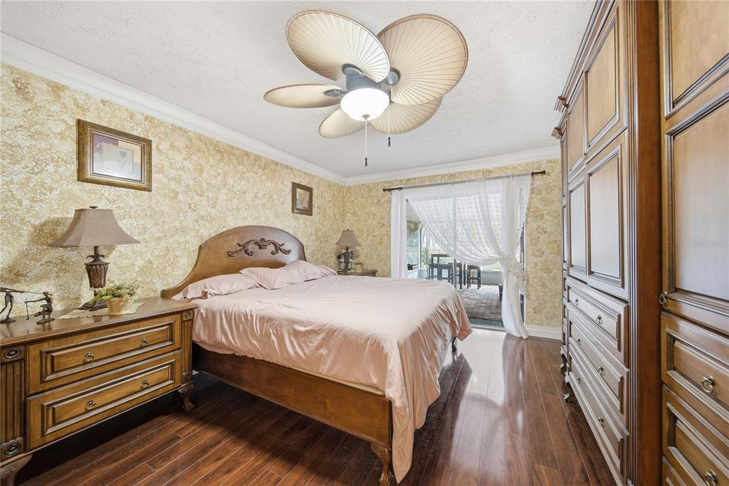 4602 Buckeye Road Tampa, FL 33624 - Photo 11 of 36 a bedroom with a bed and wooden floor