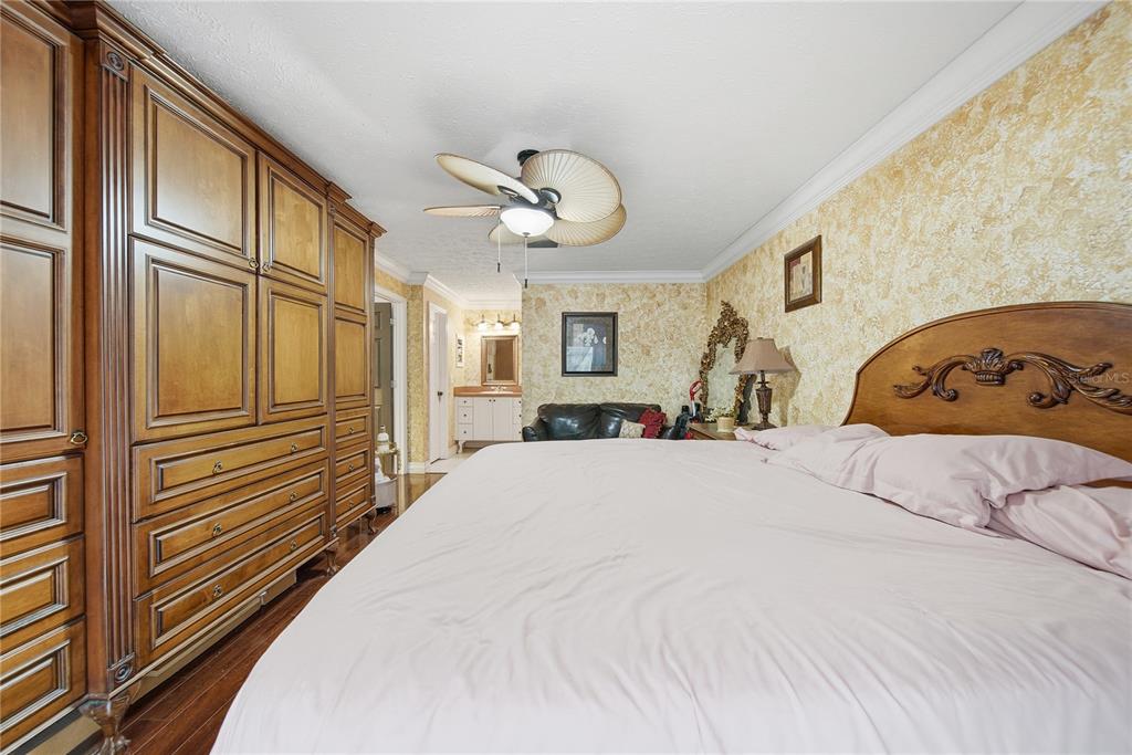 4602 Buckeye Road Tampa, FL 33624 - Photo 12 of 36 a view of a bedroom with a large bed and chandelier
