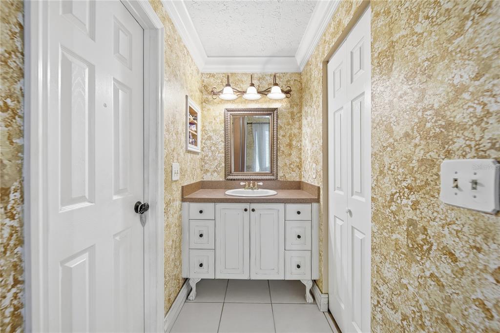 4602 Buckeye Road Tampa, FL 33624 - Photo 13 of 36 a bathroom with a double vanity sink mirror and