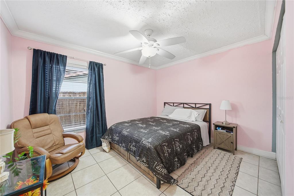 4602 Buckeye Road Tampa, FL 33624 - Photo 22 of 36 a bedroom with a bed and glass window