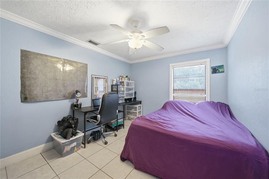 4602 Buckeye Road Tampa, FL 33624 - Photo 25 of 36 a bedroom with a bed and furniture