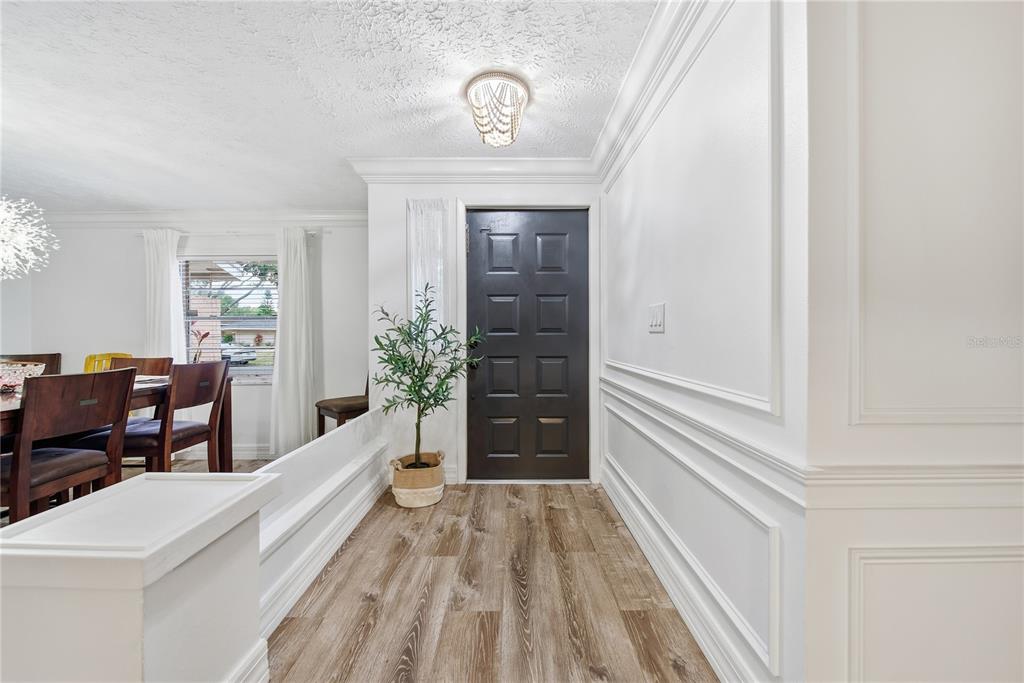 4602 Buckeye Road Tampa, FL 33624 - Photo 6 of 36 a view of a hallway to a livingroom and furniture