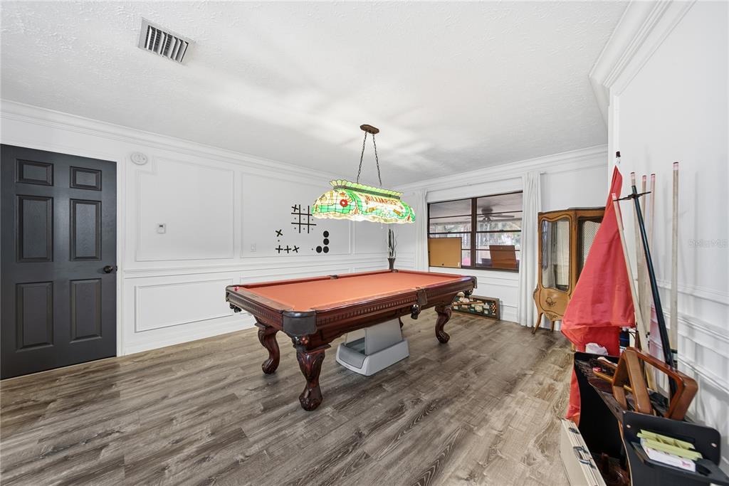 4602 Buckeye Road Tampa, FL 33624 - Photo 7 of 36 a room with furniture and a wooden floor