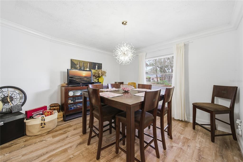4602 Buckeye Road Tampa, FL 33624 - Photo 9 of 36 a view of a dining room with furniture and wooden floor