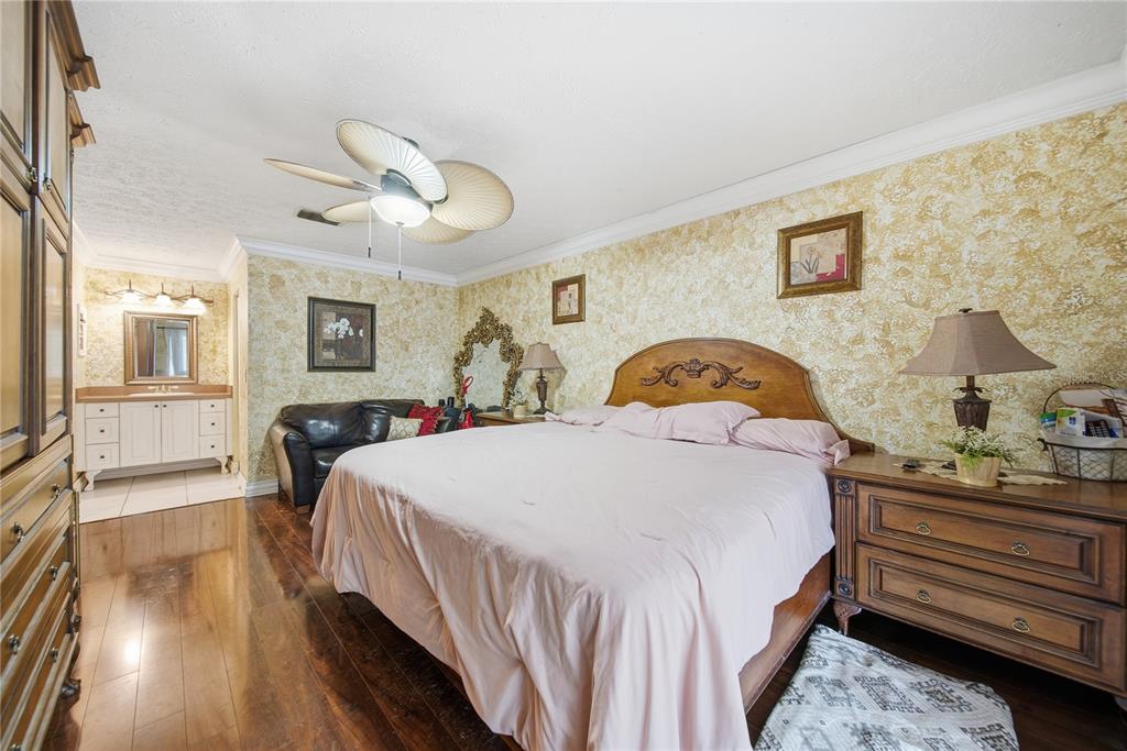 4602 Buckeye Road Tampa, FL 33624 - Photo 10 of 36 a bedroom with a bed and wooden floor