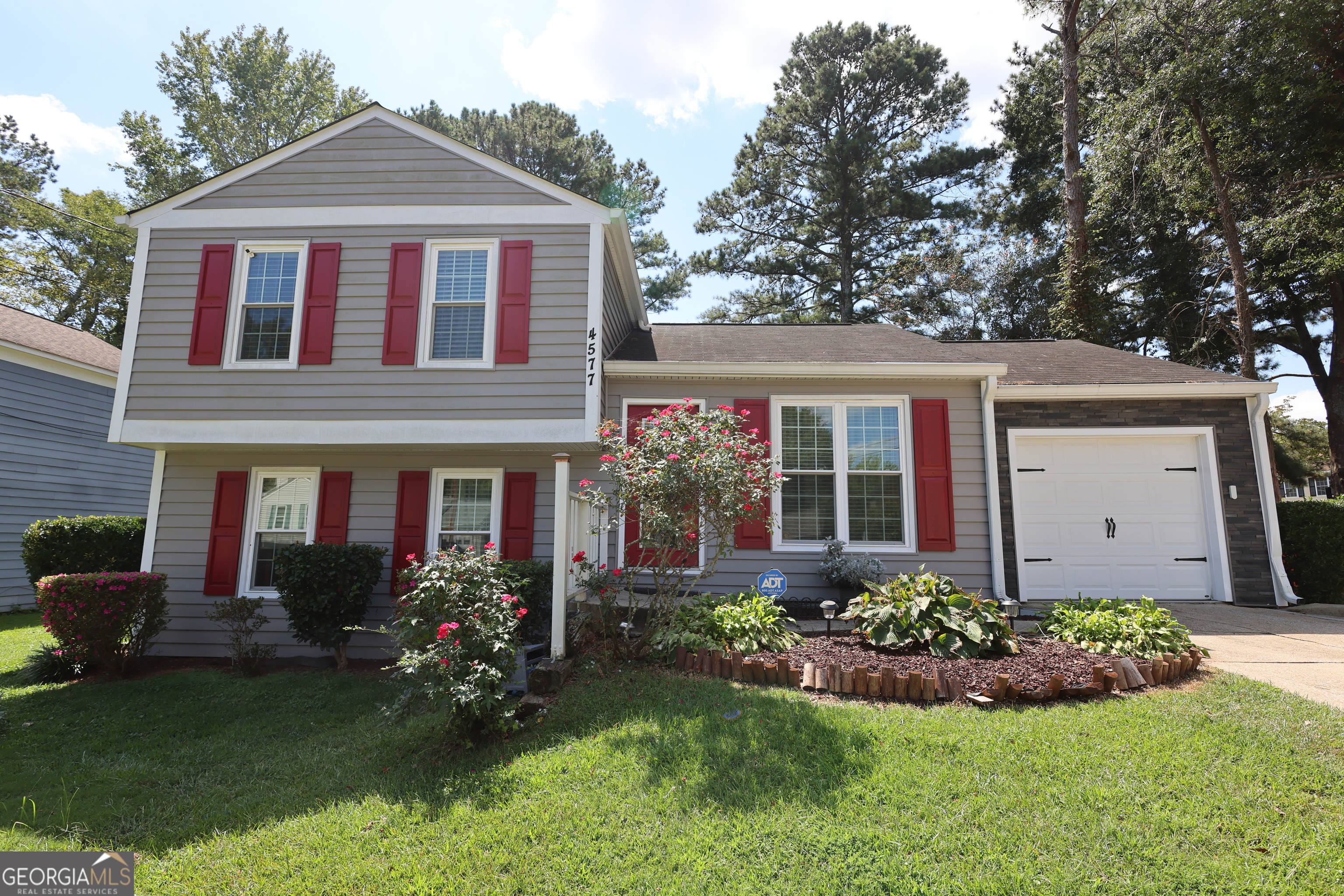 4577 Arborwalk Court Stone Mountain, GA 30083 - Photo 1 of 19 a front view of a house with a yard and porch