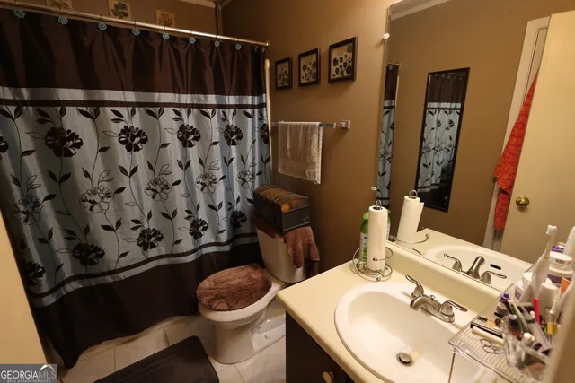 a bathroom with a sink toilet and mirror