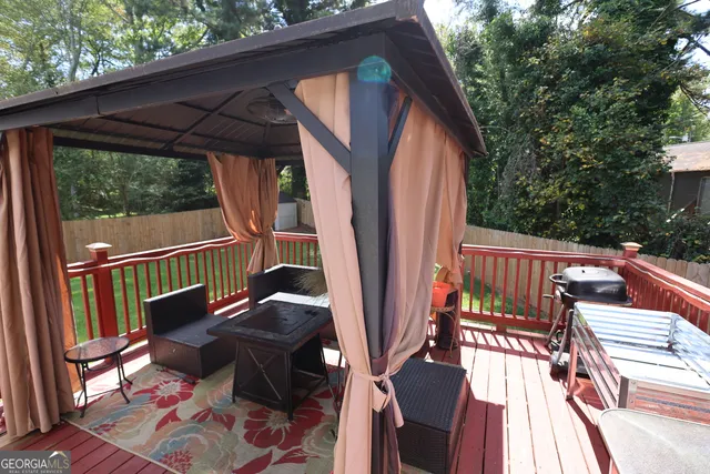 a view of balcony with wooden floor and outdoor seating