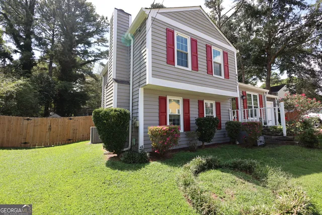 a front view of a house with a yard and plants